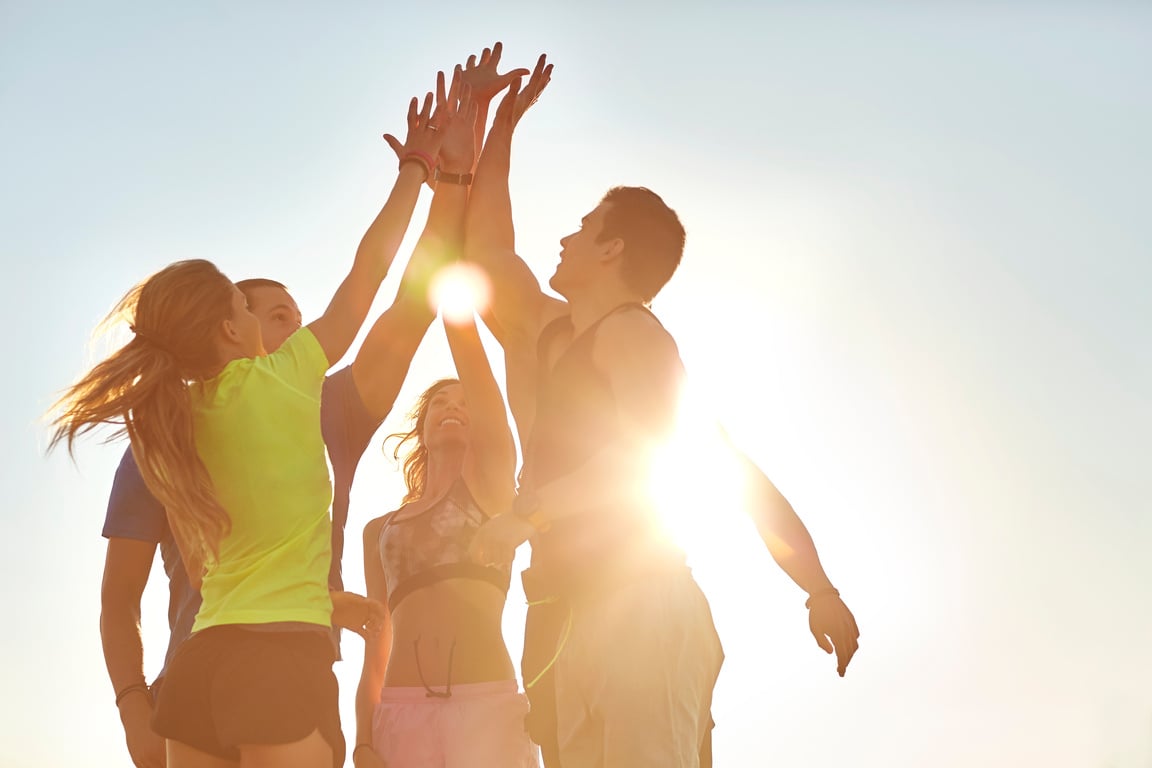 Athletes high fiving after successful workout